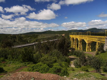 Scenic view of bridge over landscape against sky