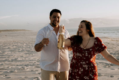 Friends standing at beach