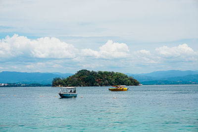 Boat sailing in sea against sky