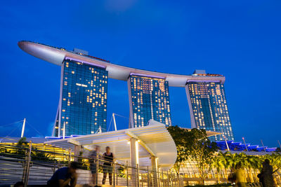 Low angle view of illuminated building against blue sky
