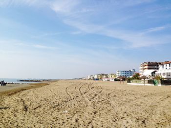 Buildings at beach against sky