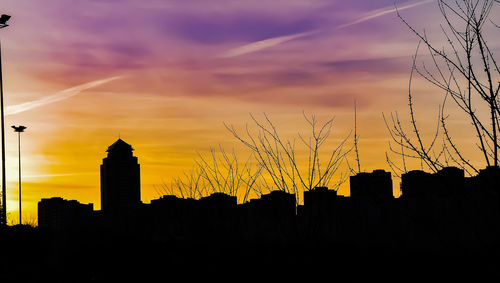 Low angle view of silhouette buildings against sky during sunset