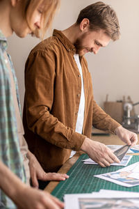 Side view of craftsperson working at workshop