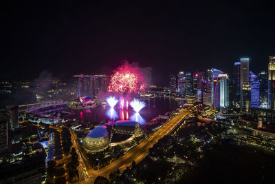 High angle view of illuminated buildings against sky at night