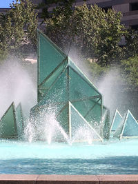 Water splashing in swimming pool against trees