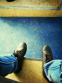 Low section of man wearing shoes