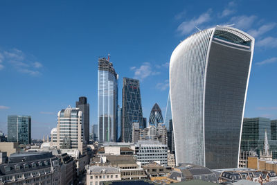 Modern buildings in city against sky