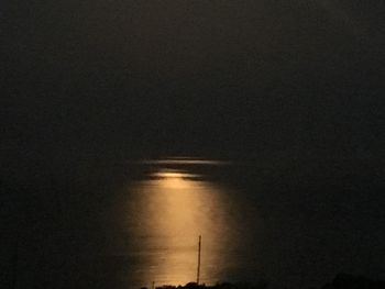 Scenic view of sea against sky at night