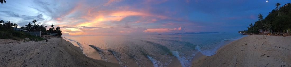 Panoramic view of beach against sky during sunset