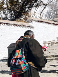 Rear view of woman standing on street