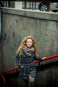 Beautiful happy woman on staircase in city