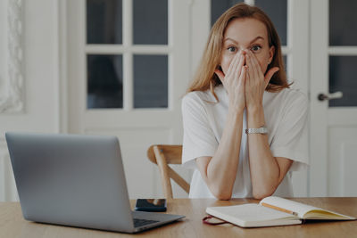 Young woman using laptop at home