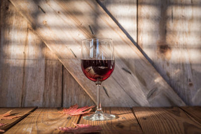 Close-up of red wine on wooden table