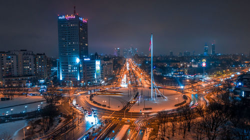 High angle view of illuminated cityscape against sky at night