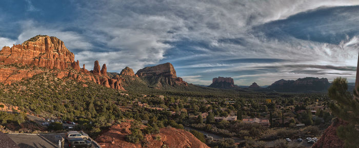 Panoramic view of canyons against cloudy sky