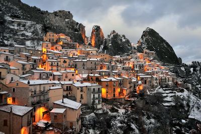 Buildings in city against sky during winter