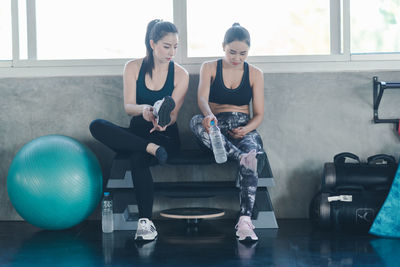 Young woman sitting by window