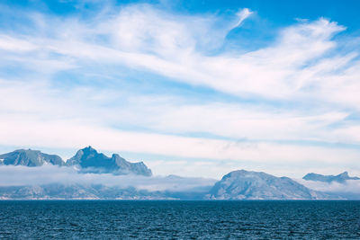 Scenic view of sea and mountains against sky