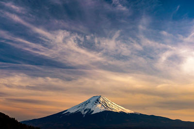 Scenic view of snowcapped mountains against sky during sunset