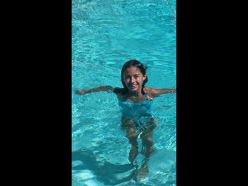 Portrait of smiling girl swimming in pool