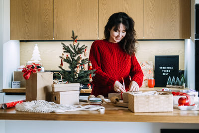 Portrait of young woman sitting on table