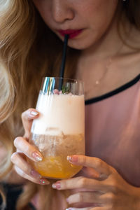 Close-up of a woman drinking glass