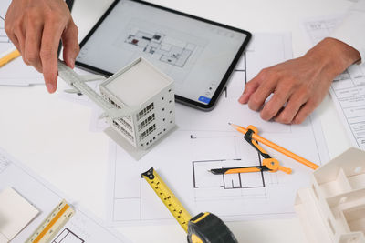 Midsection of man working on table