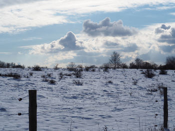 Scenic view of snow covered landscape against sky