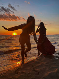 People on beach during sunset