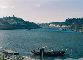 High angle view of buildings by sea against sky