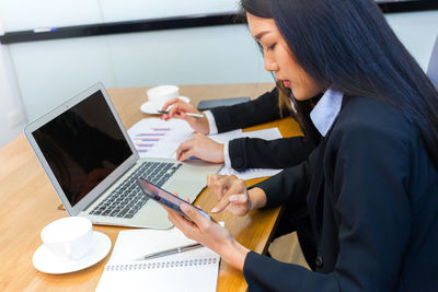 Woman using laptop on table