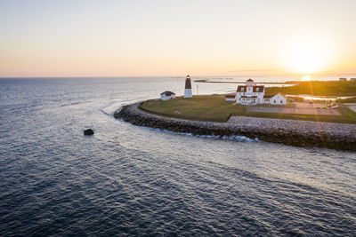 Point judith lighthouse and coast guard station at sunset aerial