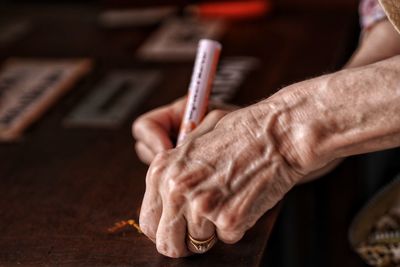 Close-up of cropped hands making craft product 