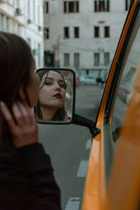 Reflection of woman on car window
