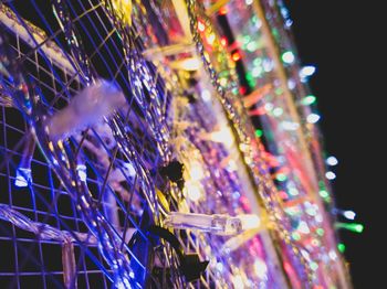 Low angle view of illuminated christmas lights at night