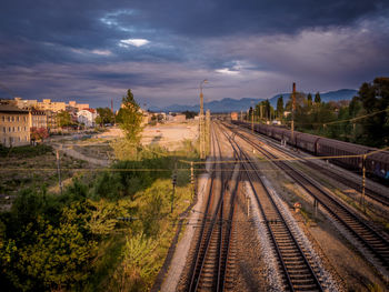 Railroad track against cloudy sky