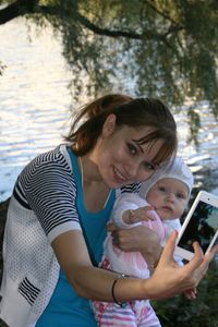 Portrait of mother and daughter taking selfie