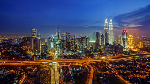 High angle view of illuminated cityscape at dusk