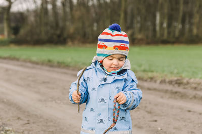 Smiling girl standing on dirt road