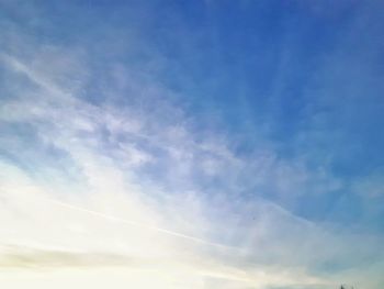 Low angle view of vapor trail in blue sky