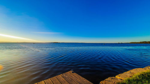 Scenic view of sea against blue sky