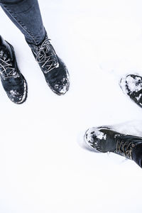 Low section of person standing on snow