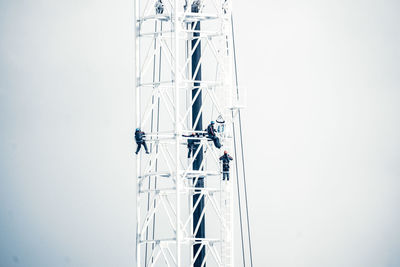 Low angle view of communications tower against sky