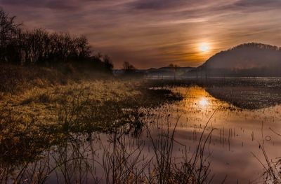 Scenic view of lake at sunset