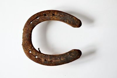 Close-up of rusty metal against white background