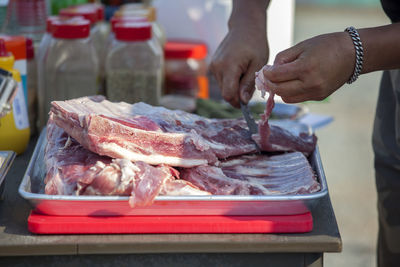 Chef cutting beef in kitchen counter