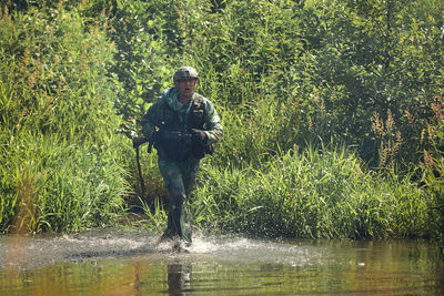 Rear view of man standing in lake