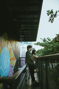 Rear view of couple walking on staircase