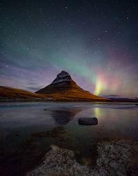 Scenic view of lake against sky at night