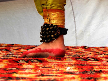Low section of woman standing on red floor
